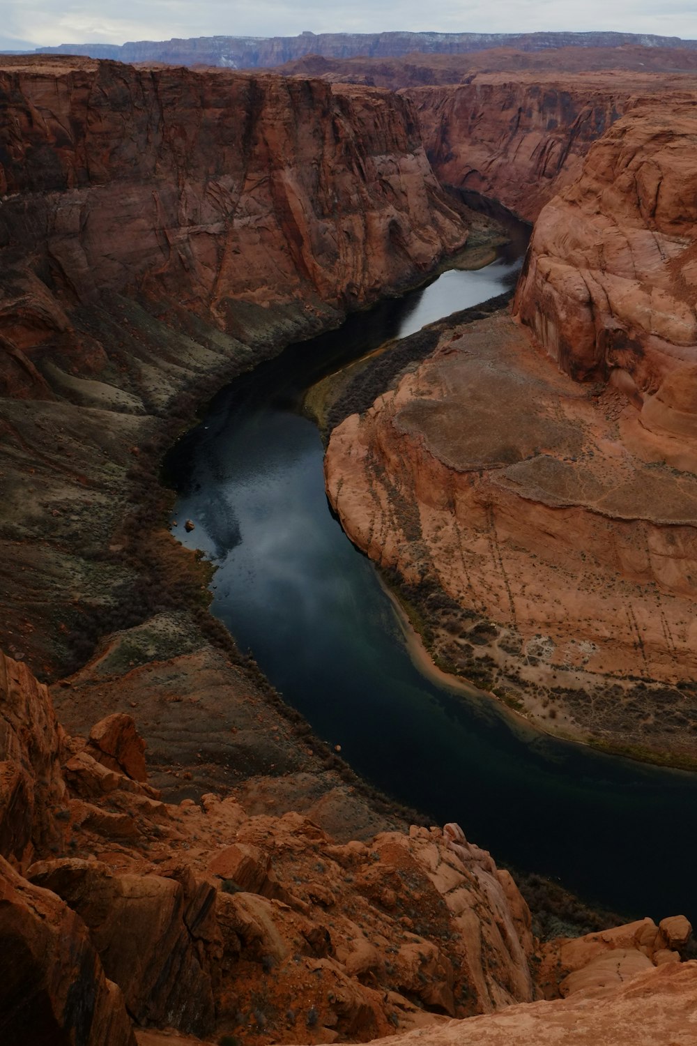 a river running through a canyon surrounded by mountains