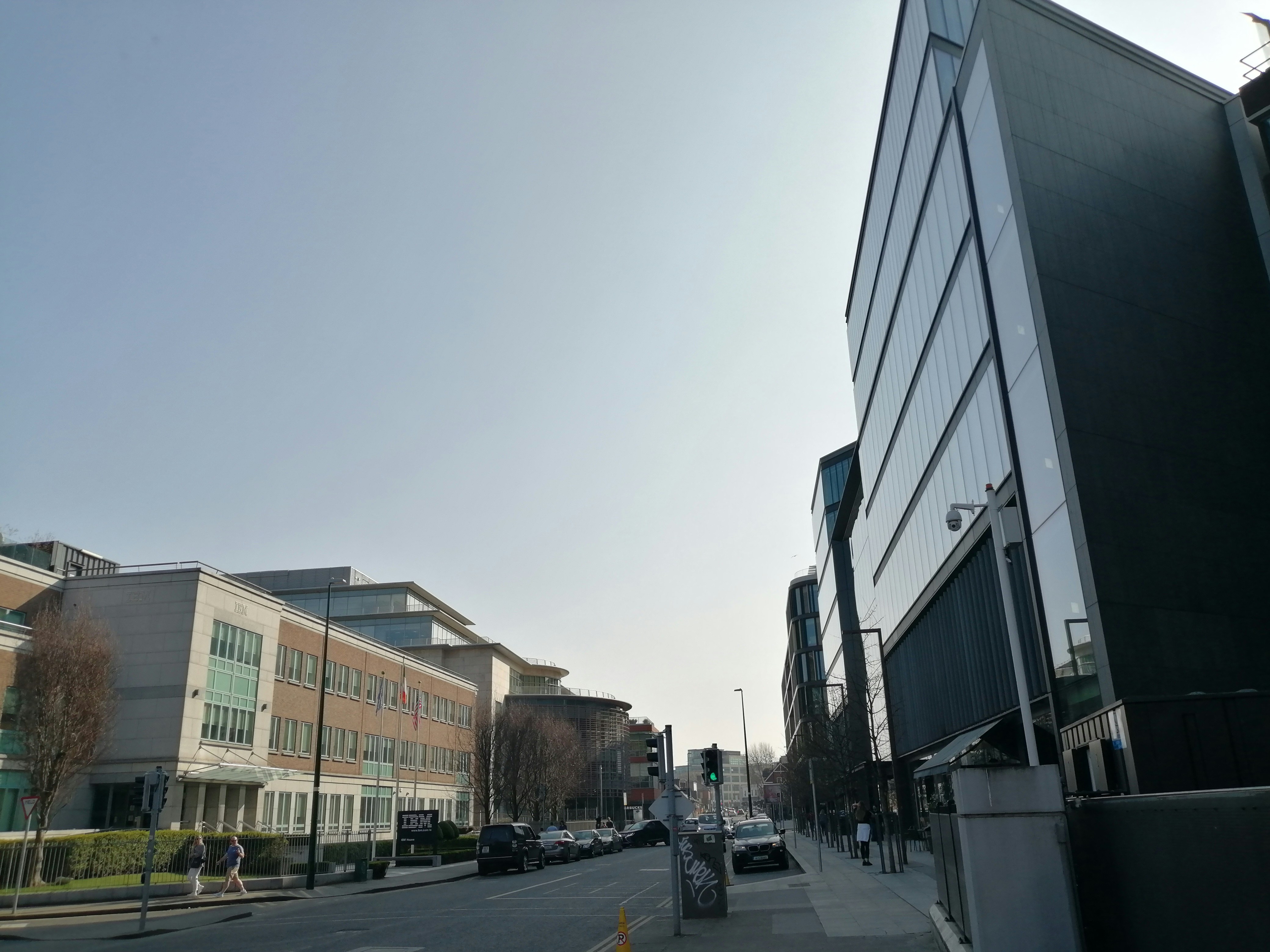 A city street lined with tall buildings and parked cars photo – Free ...