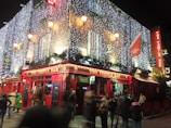 A vibrant bar scene with guests enjoying drinks outdoors.