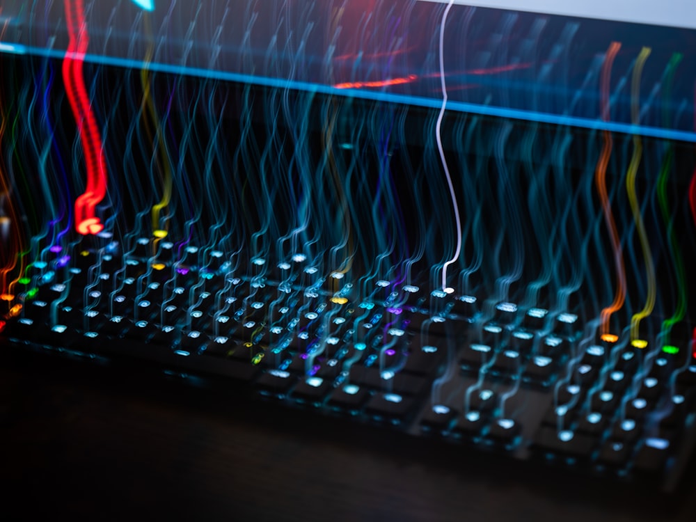 a close up of a computer keyboard with colorful lights