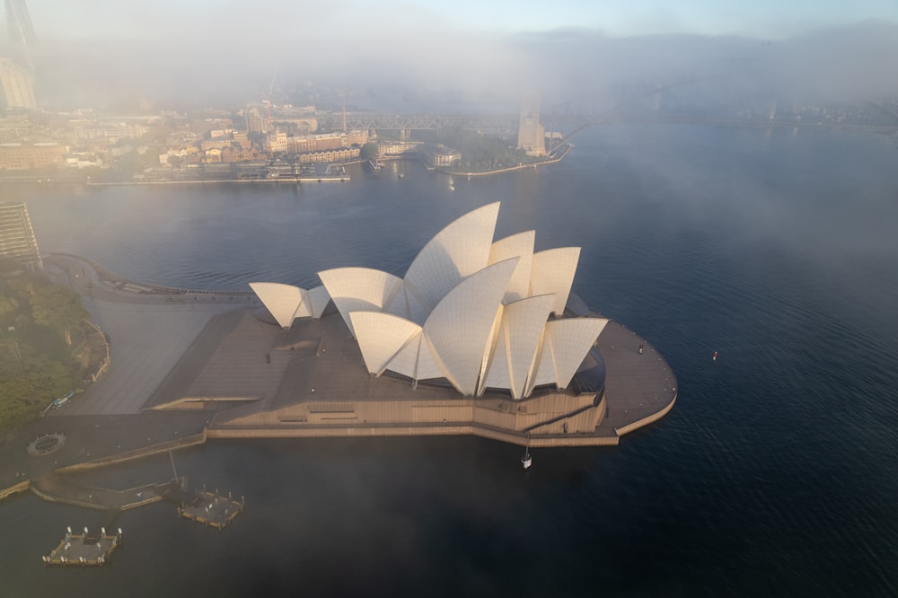 an aerial view of the sydney opera on a foggy day
