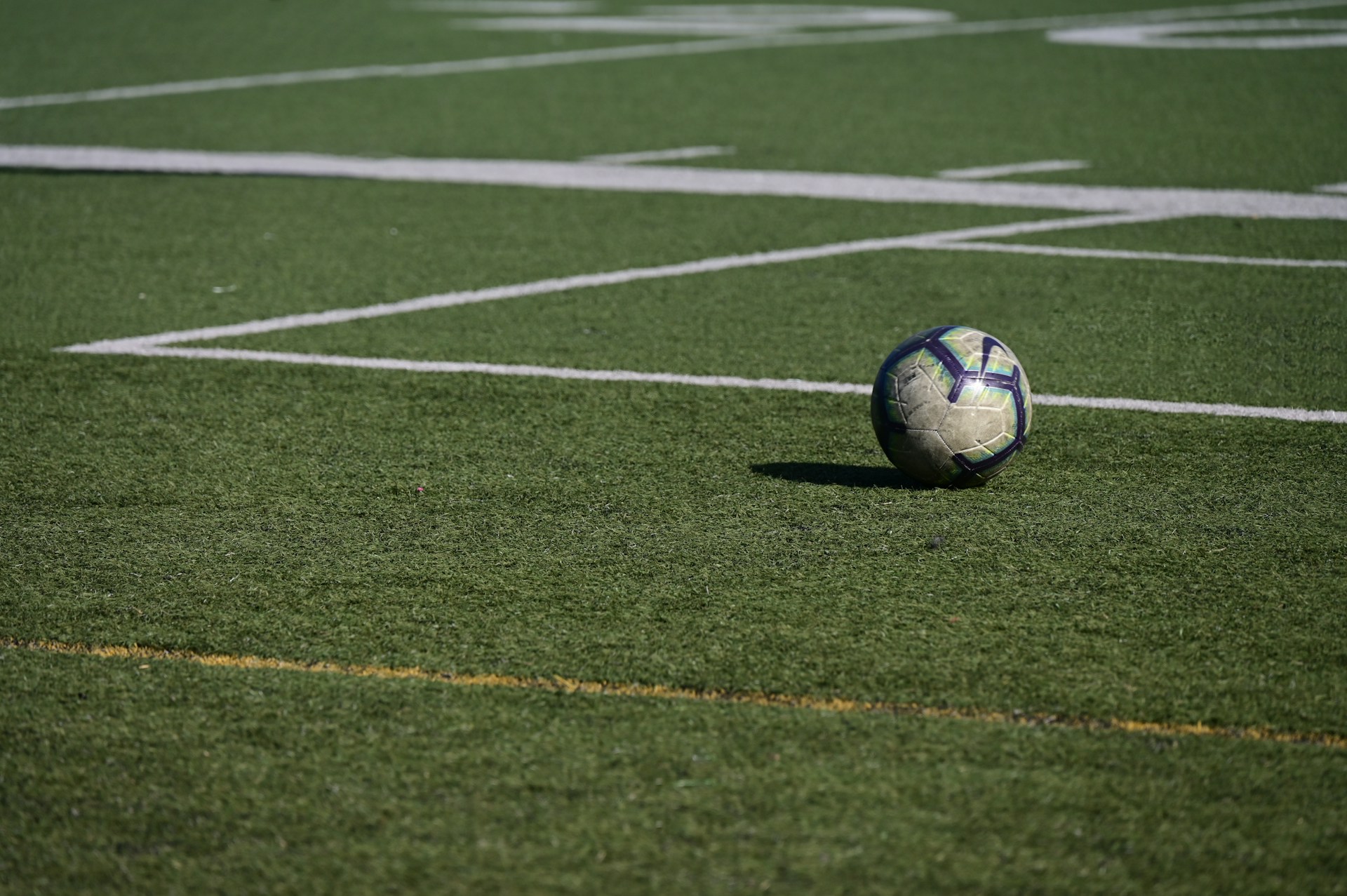 a soccer ball sitting on top of a soccer field
