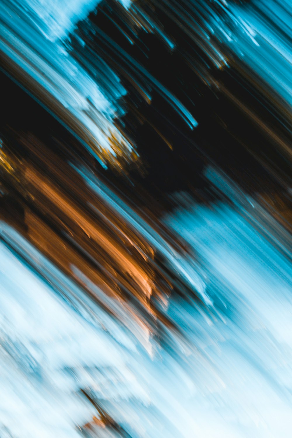a blurry photo of a snowboarder going down a hill