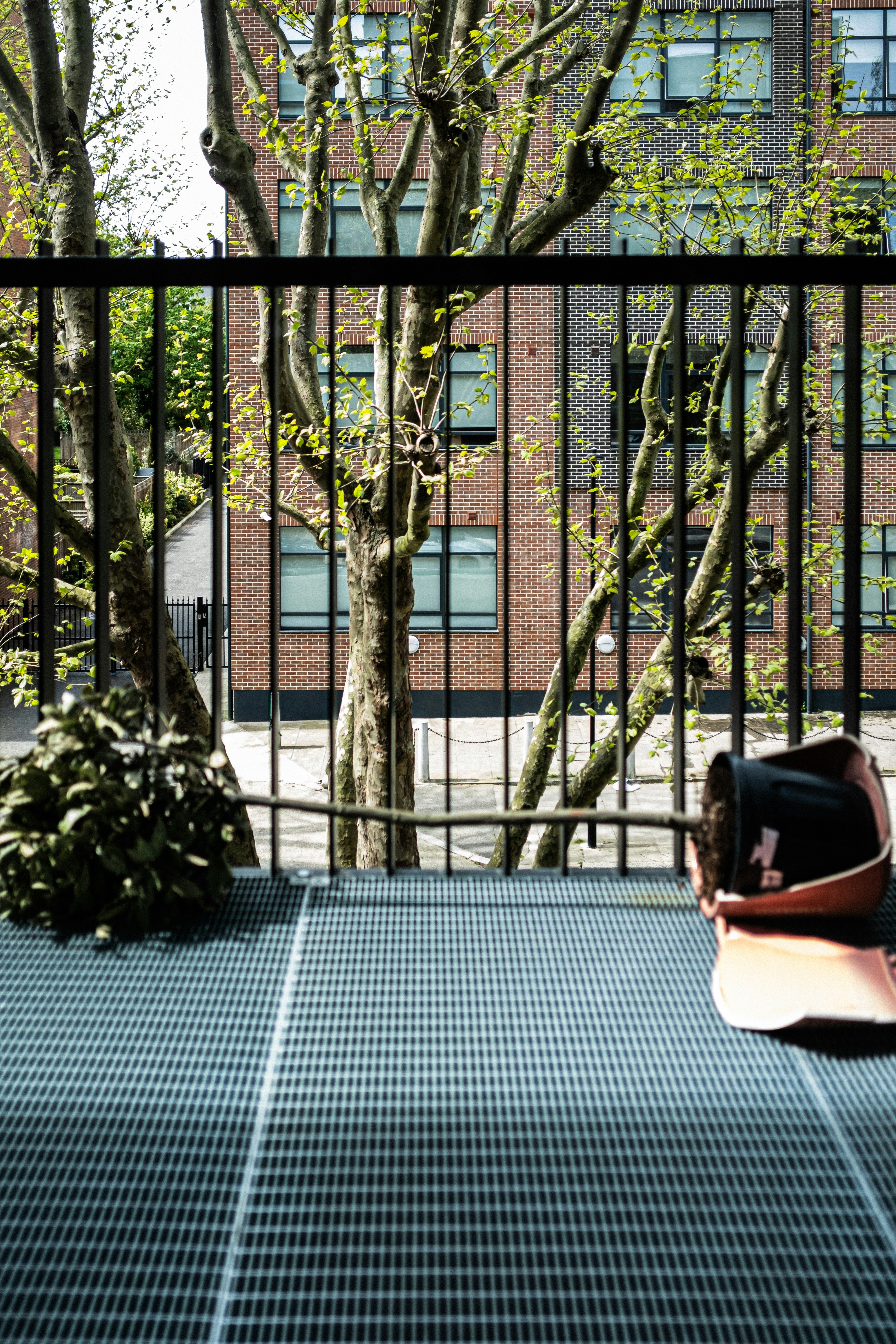 a bag is sitting on the ground in front of a fence