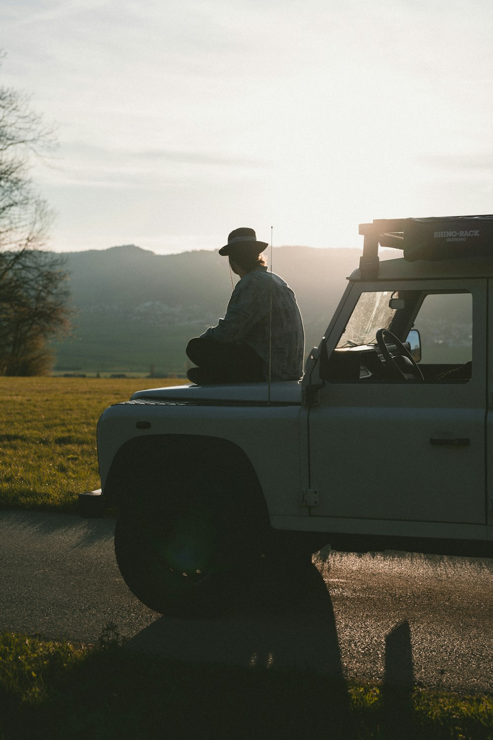a man sitting in the back of a white truck