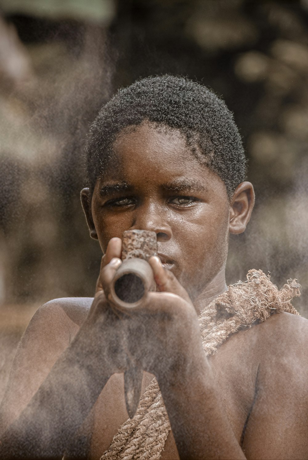 a young boy holding a bottle in his hands