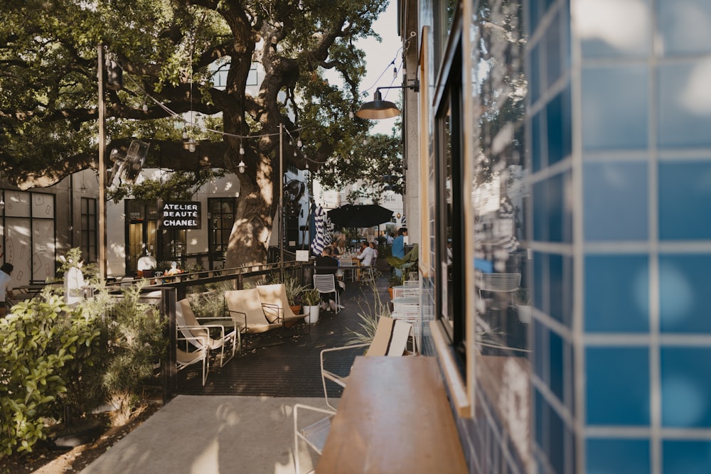 a group of people sitting outside of a restaurant