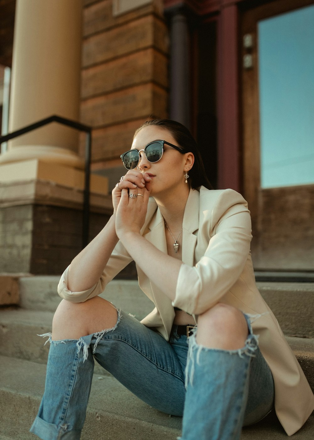 a woman sitting on the steps of a building