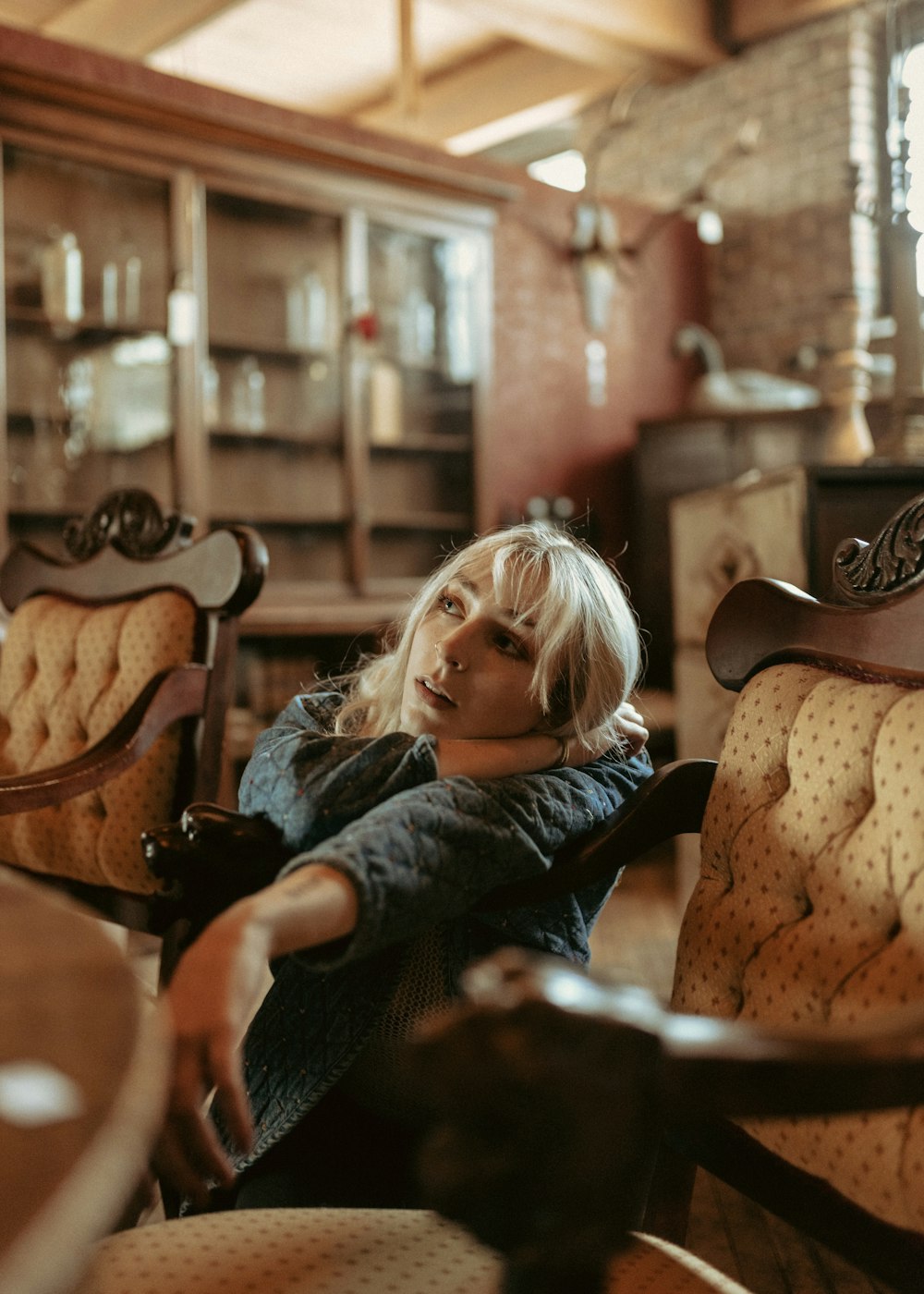 a woman sitting on a chair in a room