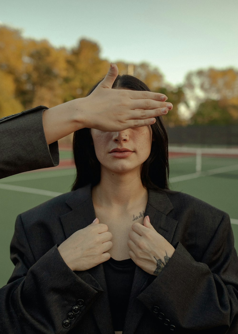 a woman holding her hands up to her face