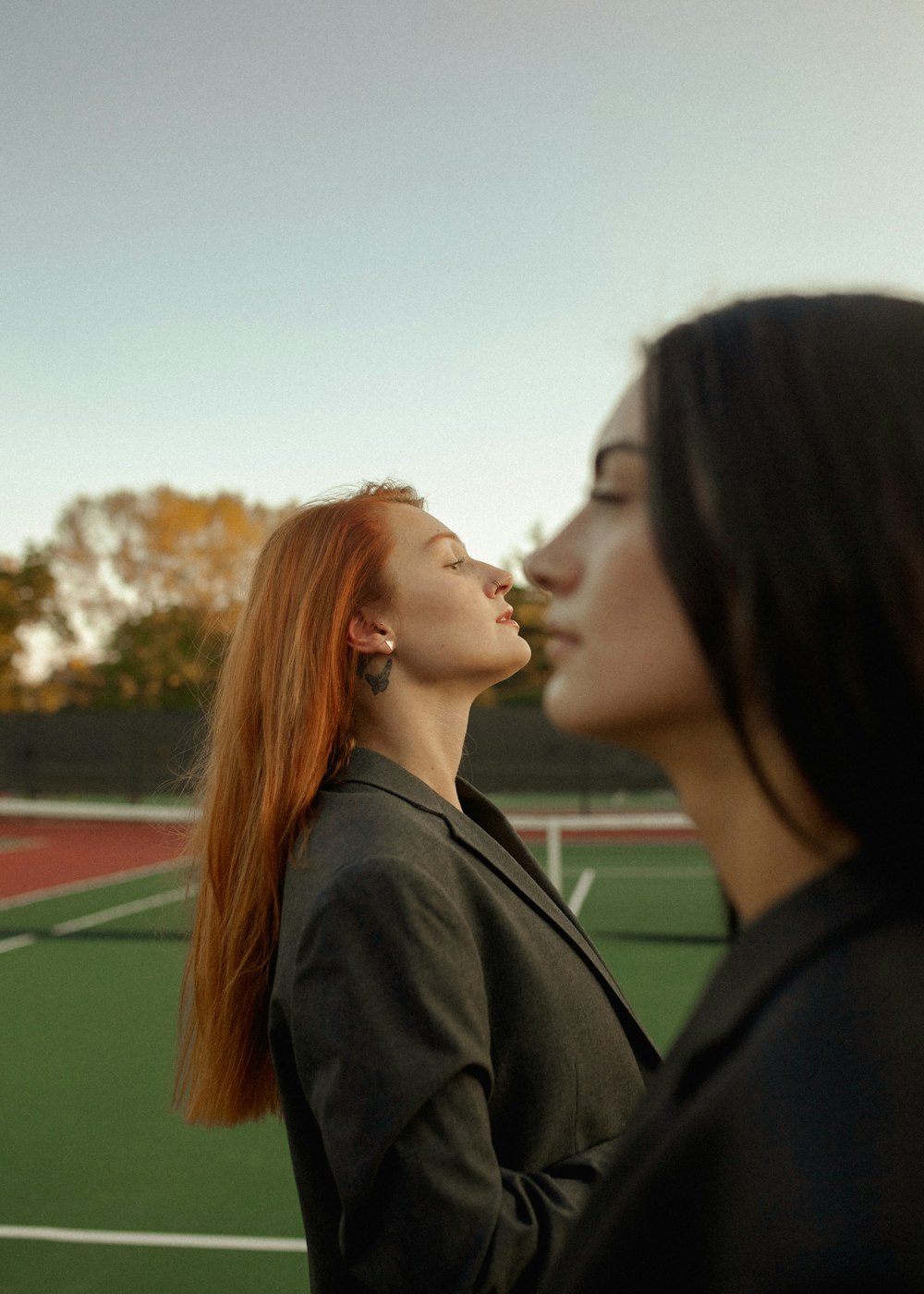 a couple of women standing on top of a tennis court