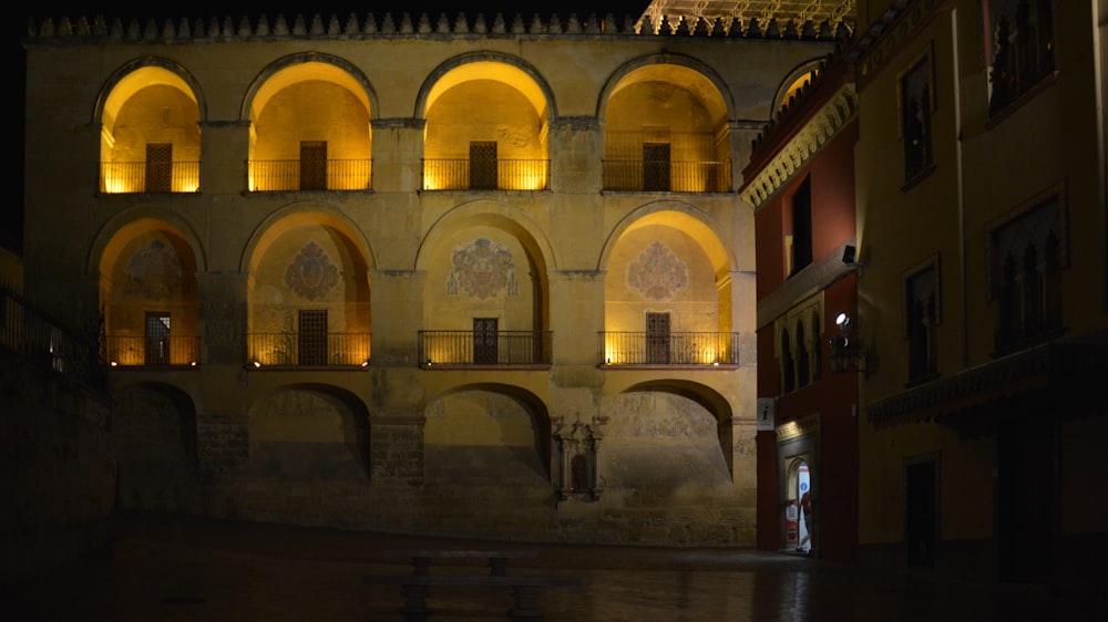 a building lit up at night with lights on