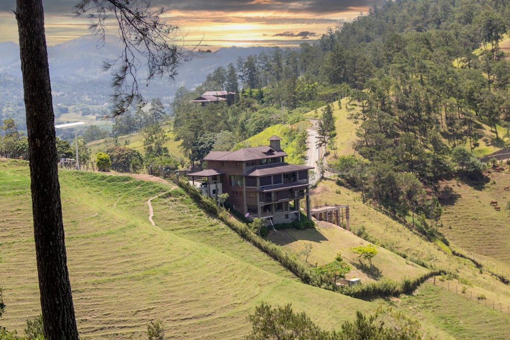 a large house sitting on top of a lush green hillside
