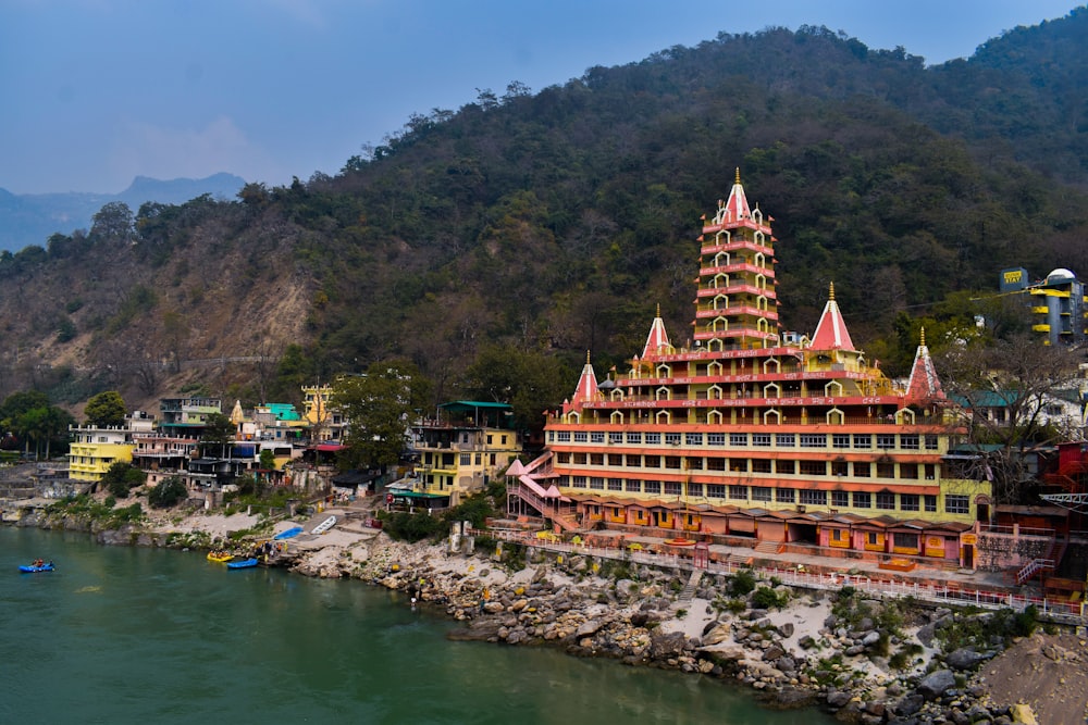 a very tall building sitting on the side of a river