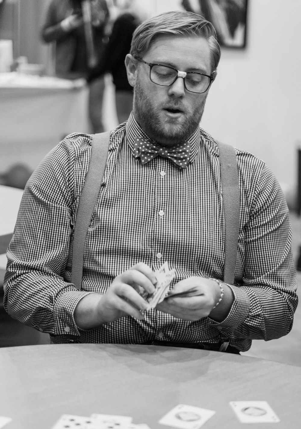 a man sitting at a table playing a game of dominos