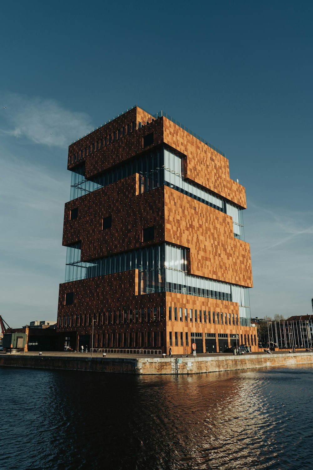 a tall building sitting next to a body of water