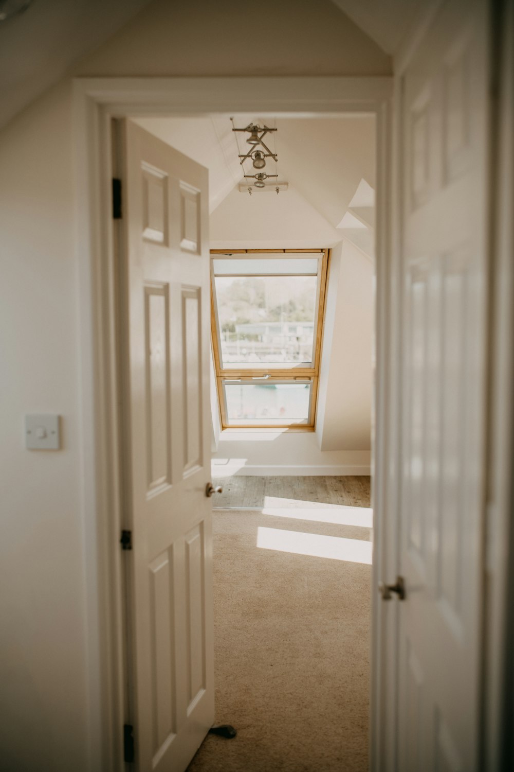 an open door leading to a room with a window