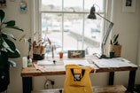 Workspace corner with desk, chair, and natural light.