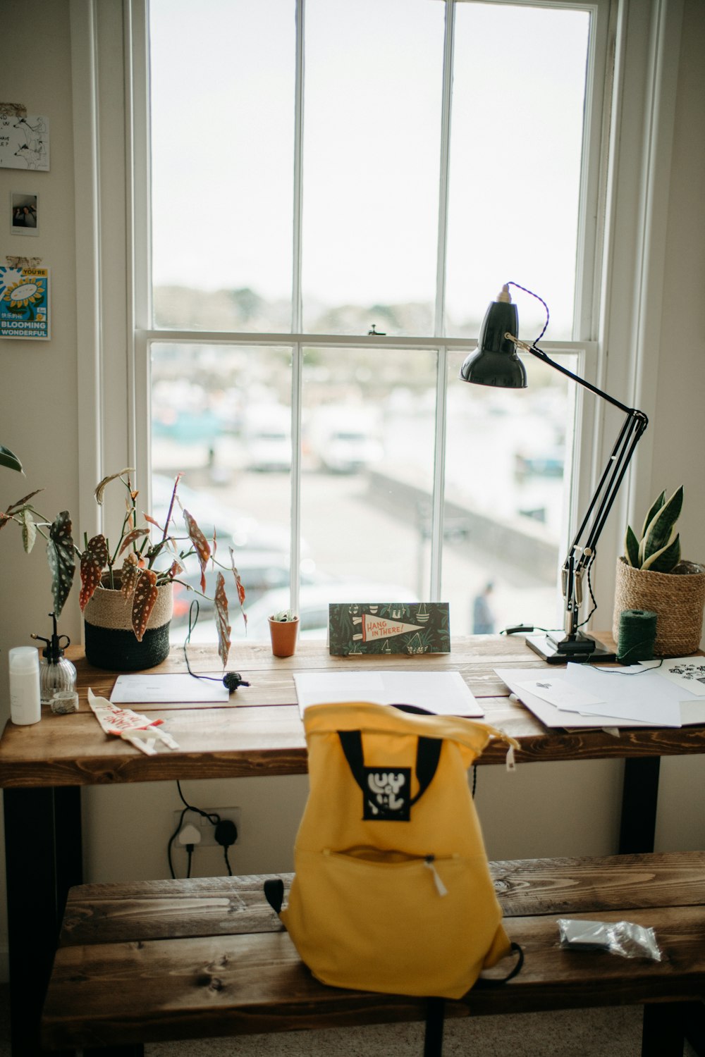 a yellow backpack sitting on top of a wooden table