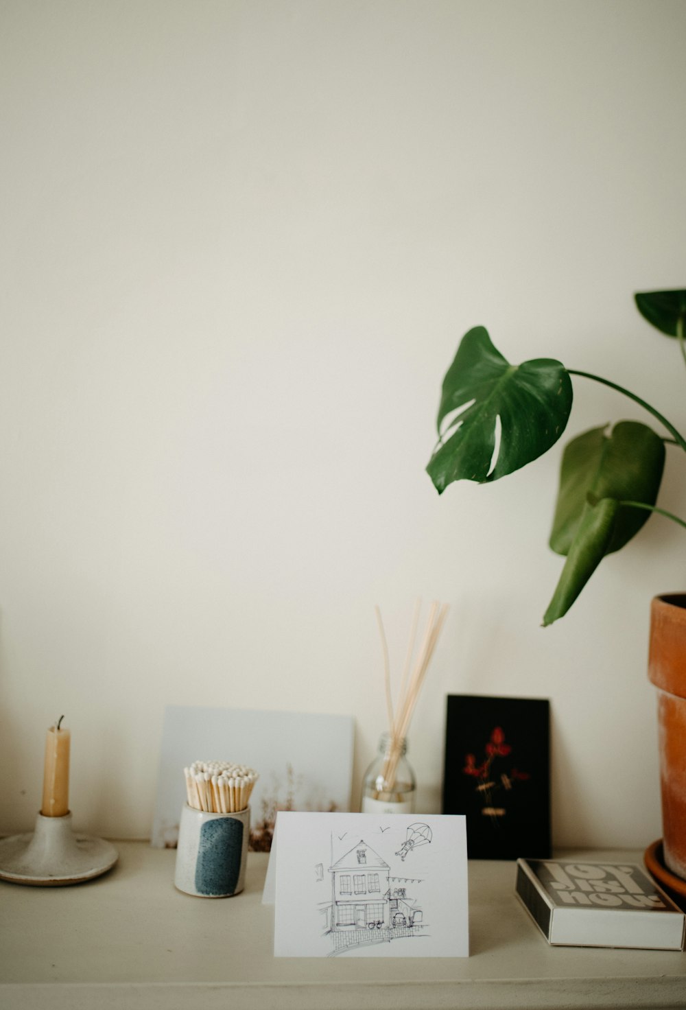 a desk with a plant and a card on it