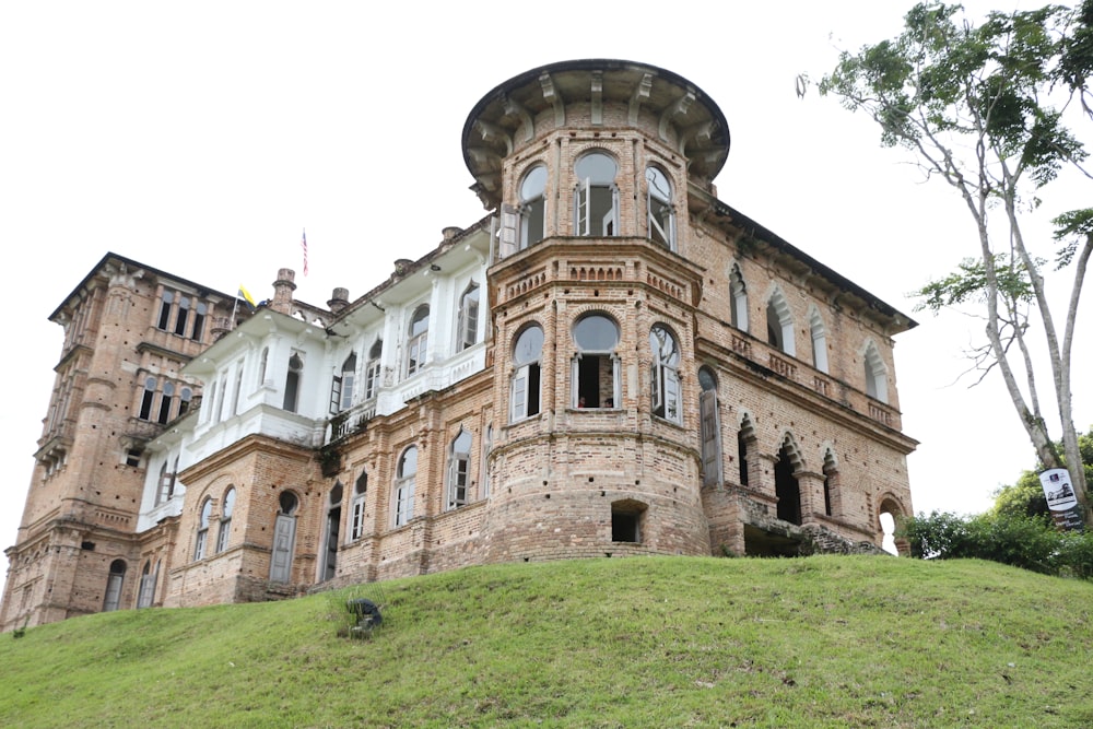 a large building sitting on top of a lush green hillside