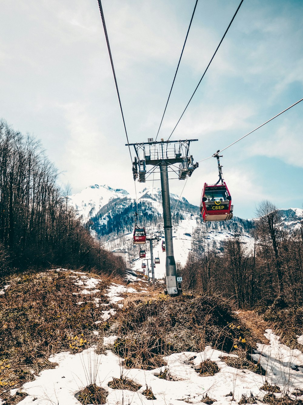 a ski lift going up a snowy mountain