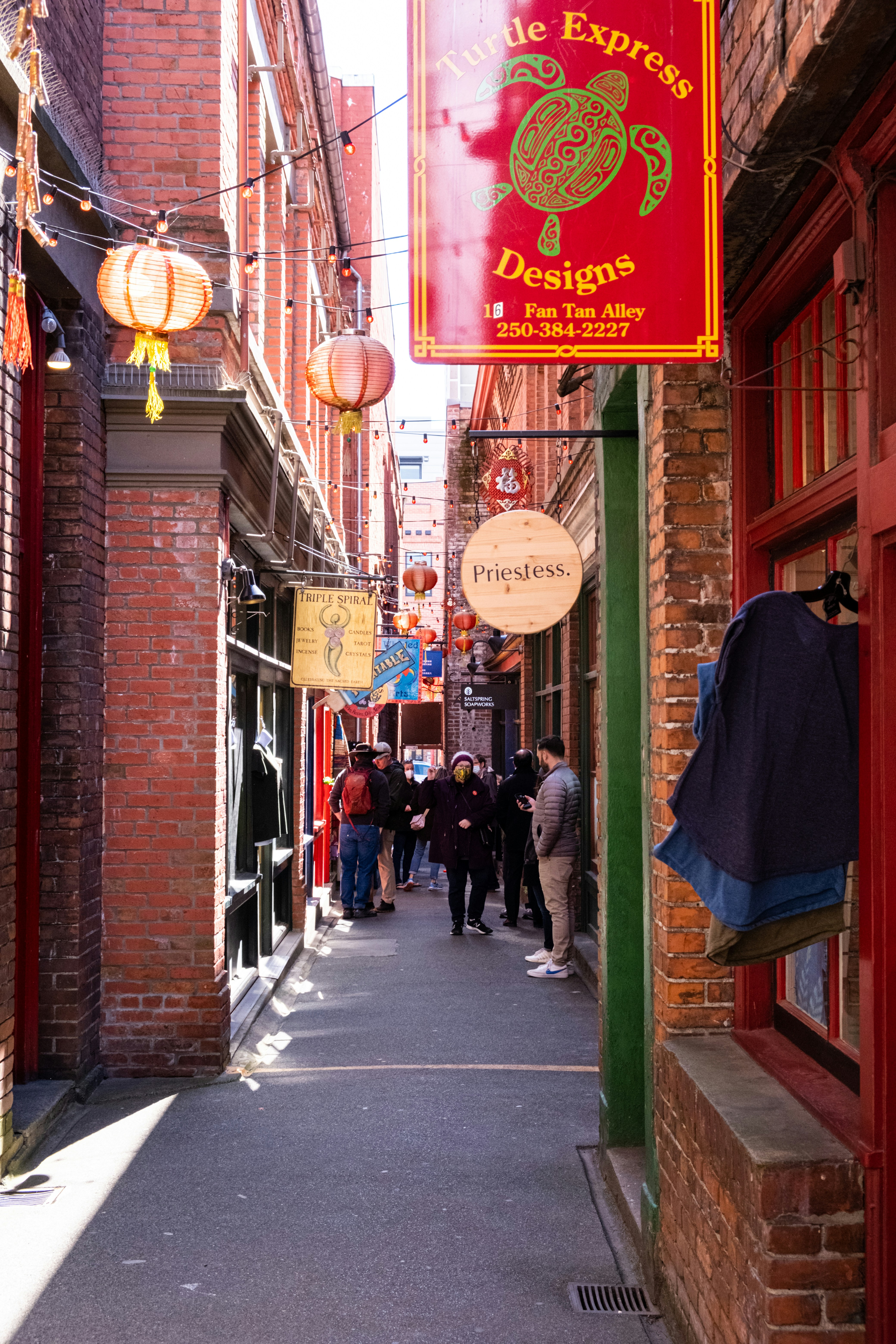 a group of people walking down a narrow street