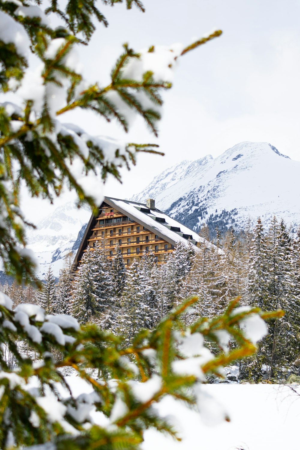 a house in the snow with a mountain in the background