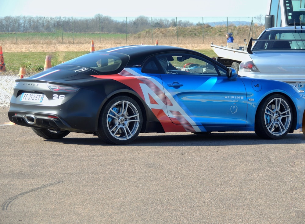 a blue sports car parked in a parking lot