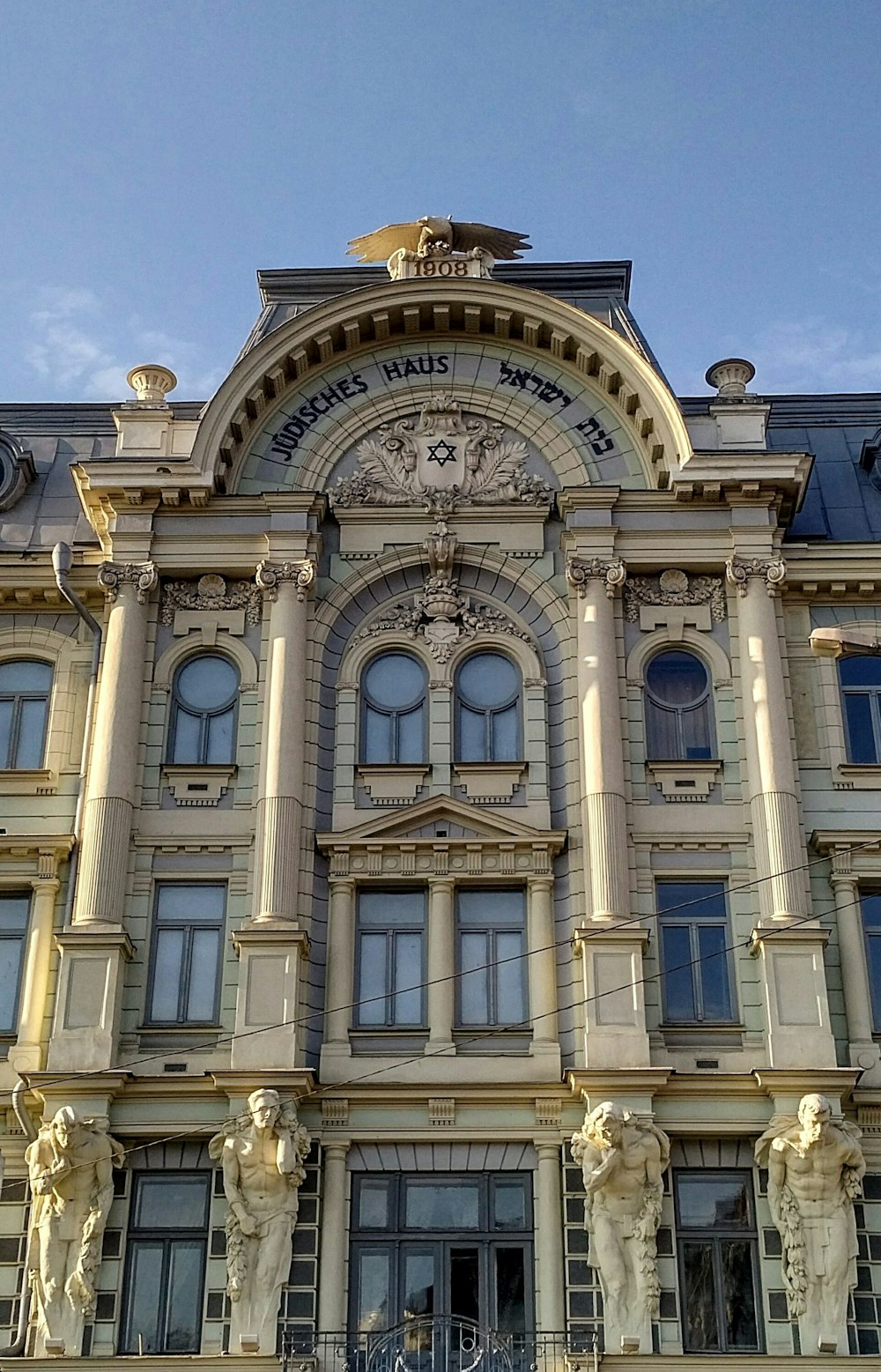 a large building with statues on the front of it