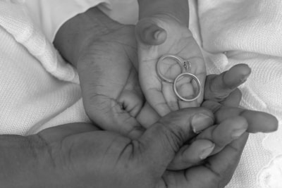 a black and white photo of a couple holding hands