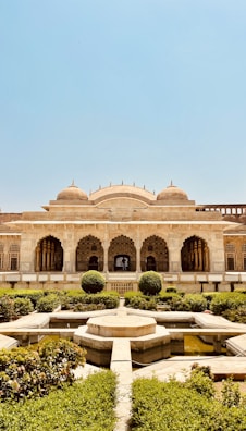a large building with a fountain in the middle of it