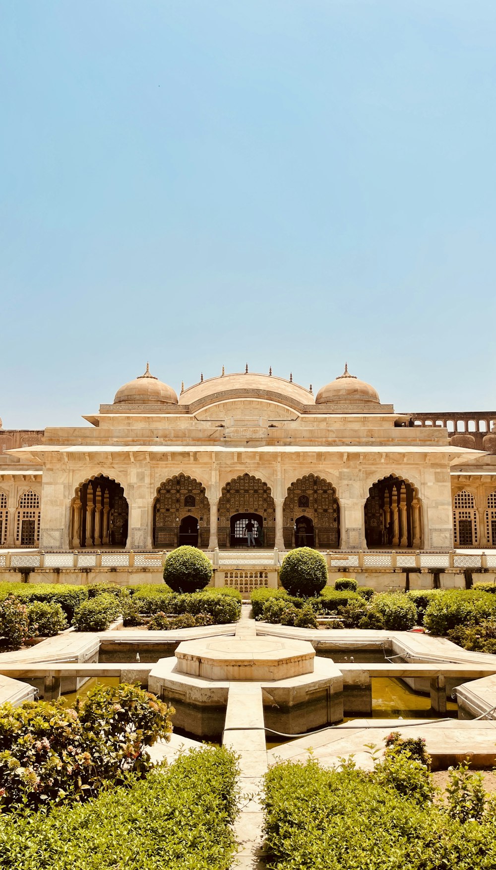 a large building with a fountain in the middle of it