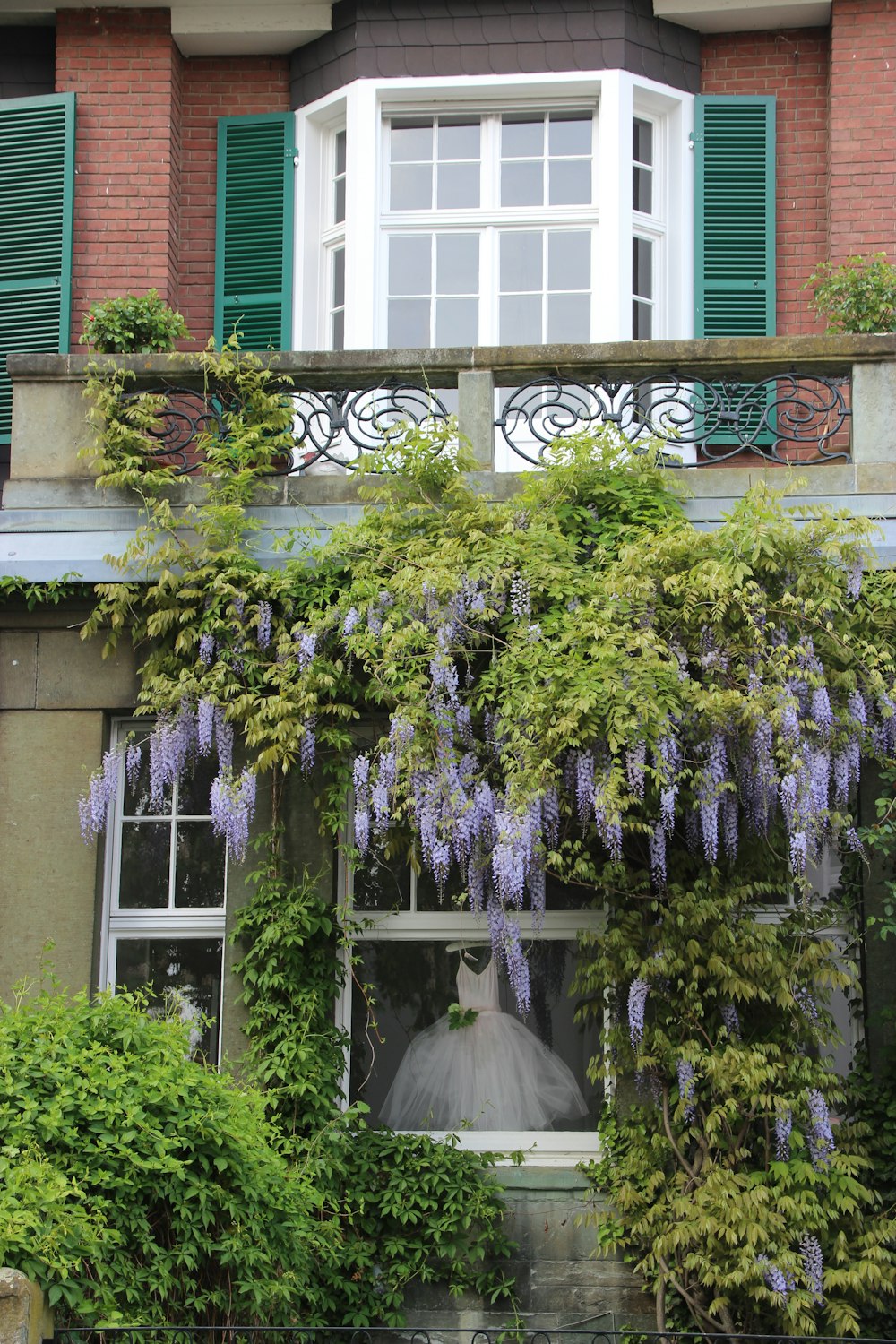 a bride's dress is seen through the window of a building