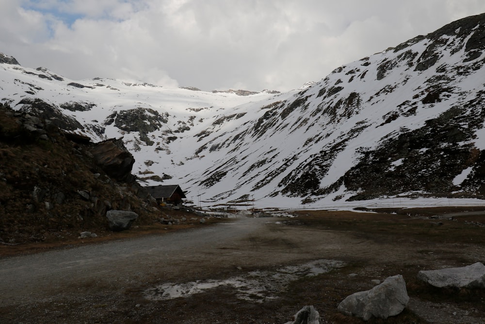 a snowy mountain with a road going through it