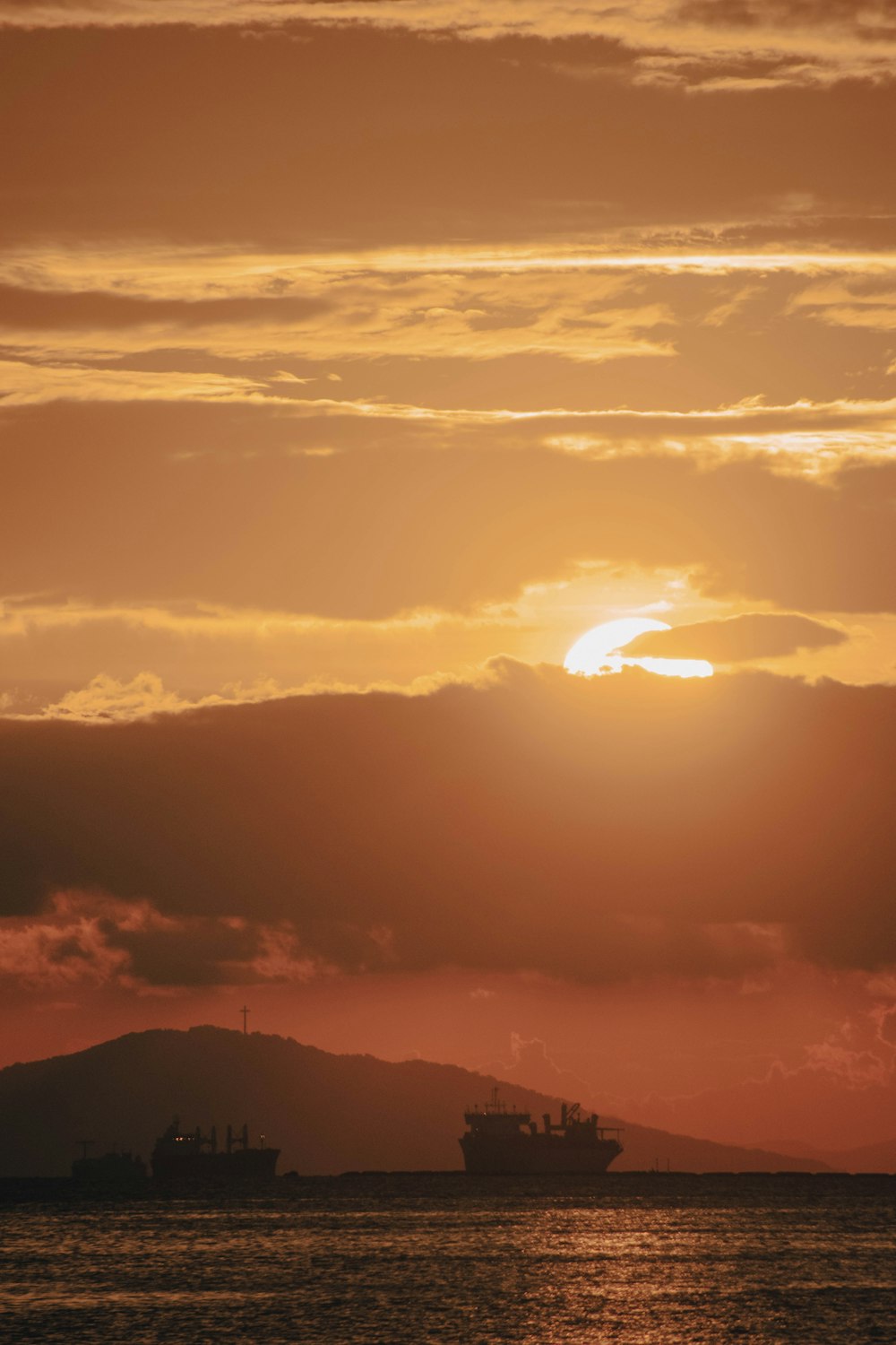 the sun is setting over a large body of water