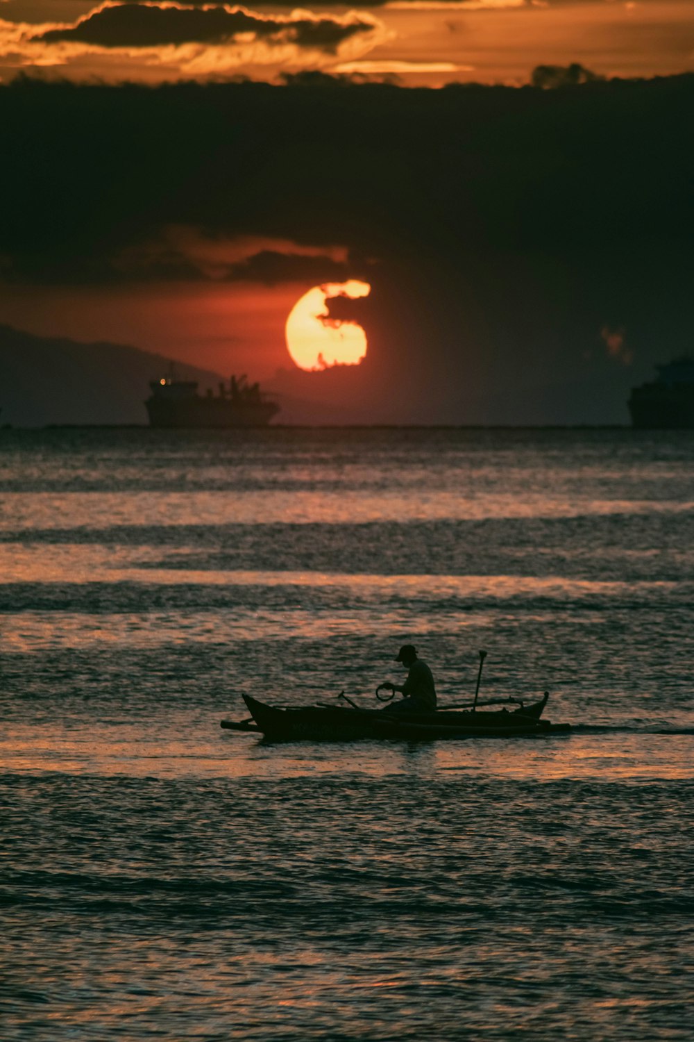 a person in a small boat in the water