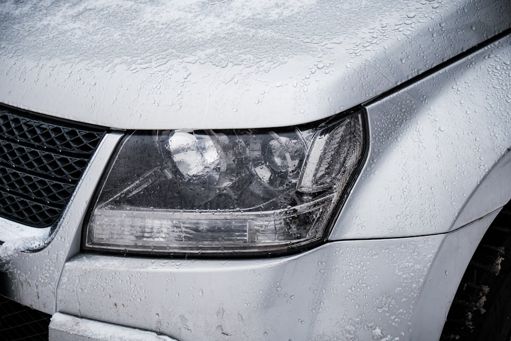 a close up of a car with snow on it