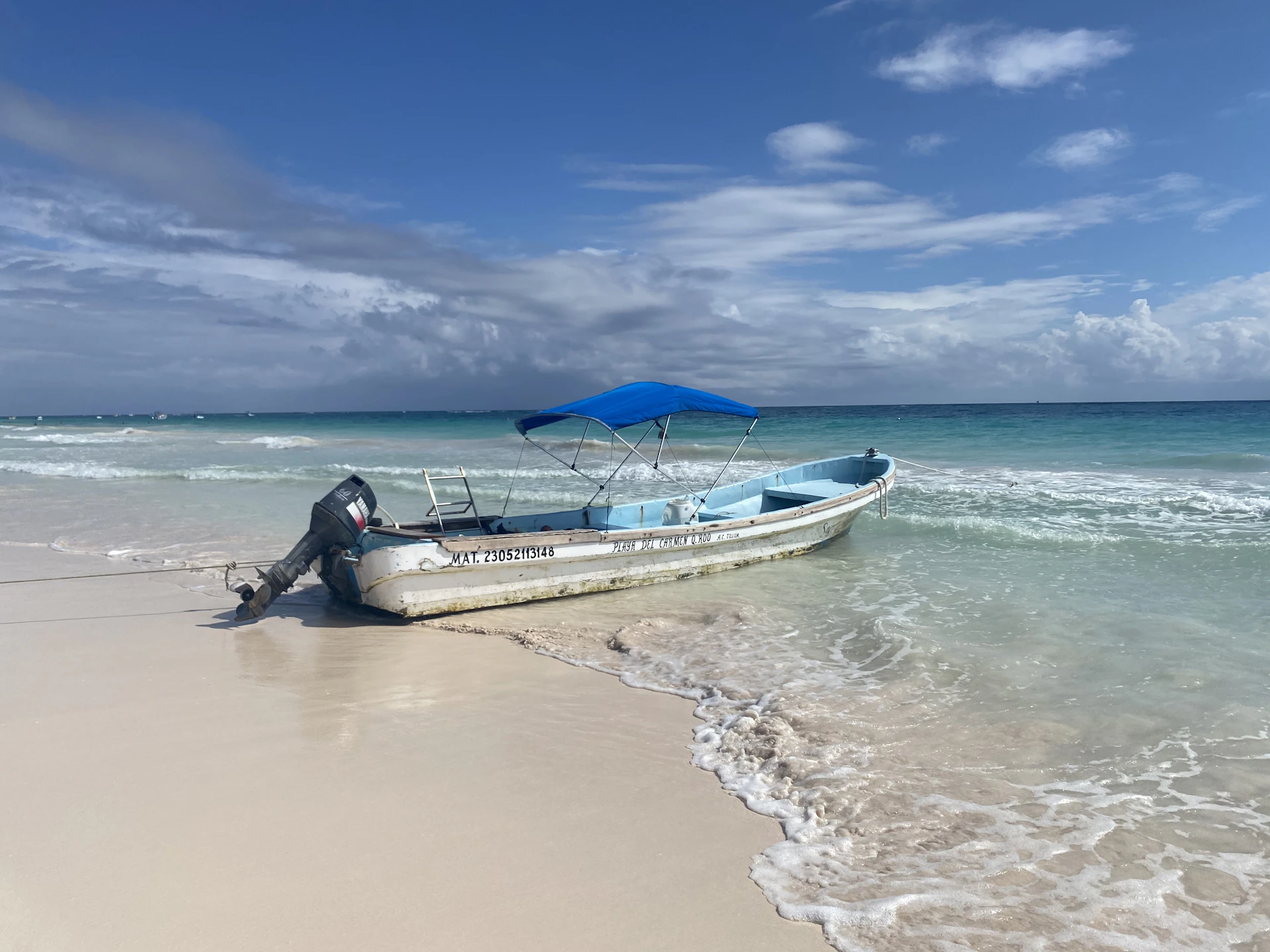 a boat sitting on top of a sandy beach