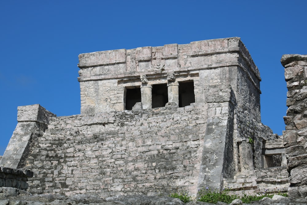 a stone structure with two windows on top of it