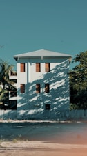 a large white building with many windows and a fence