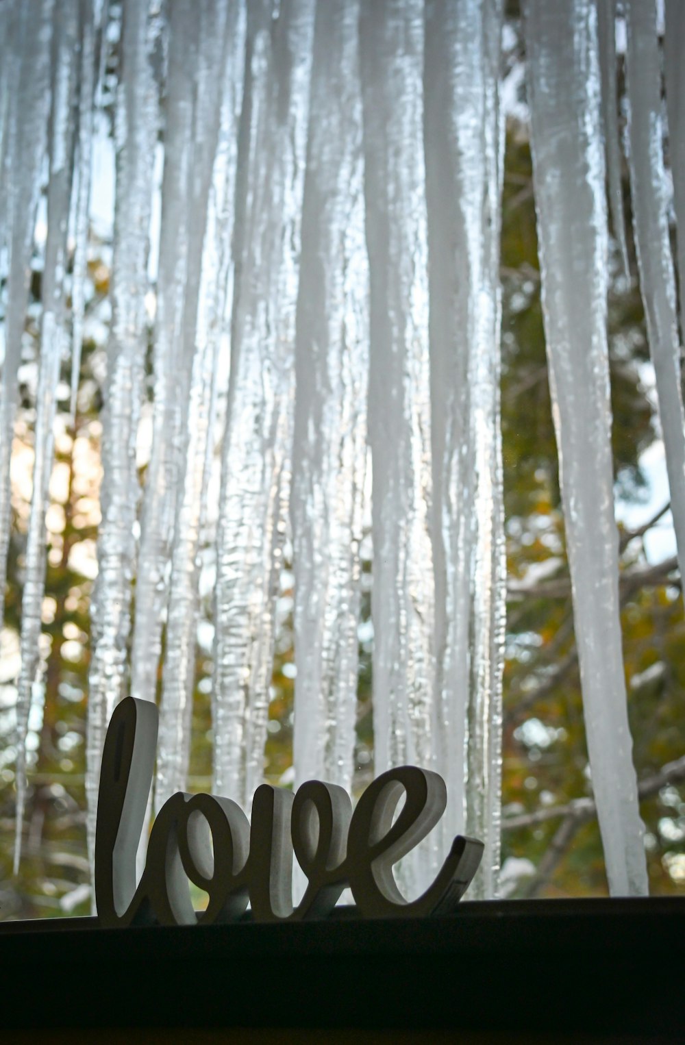 a close up of a window with icicles on it