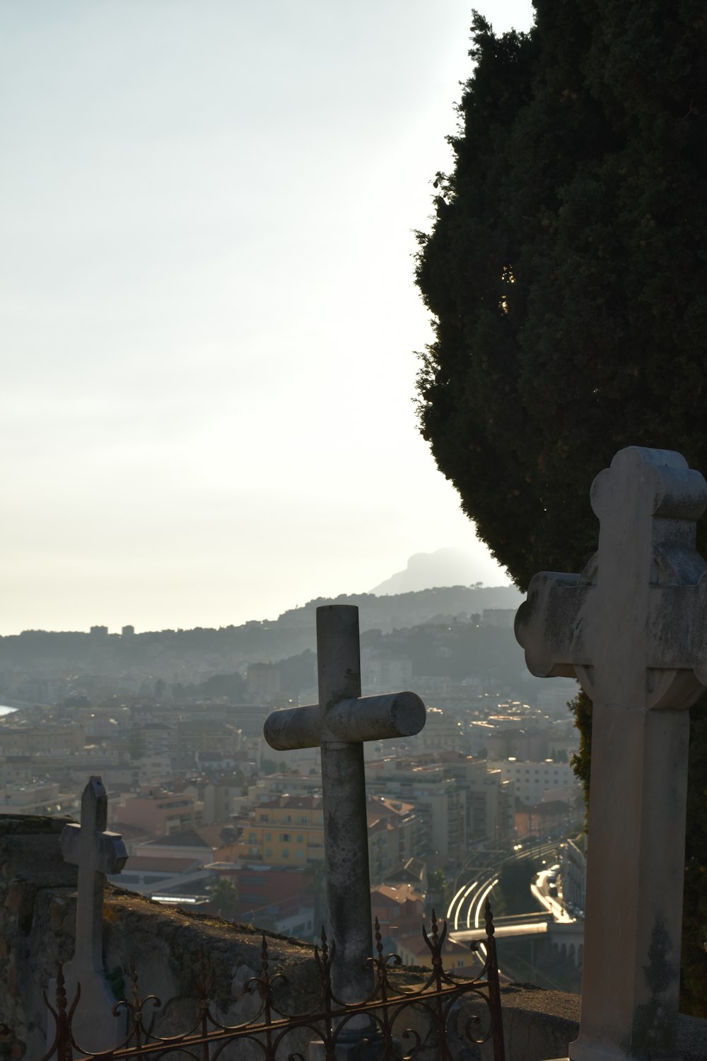 a view of a cemetery with a cross in the foreground