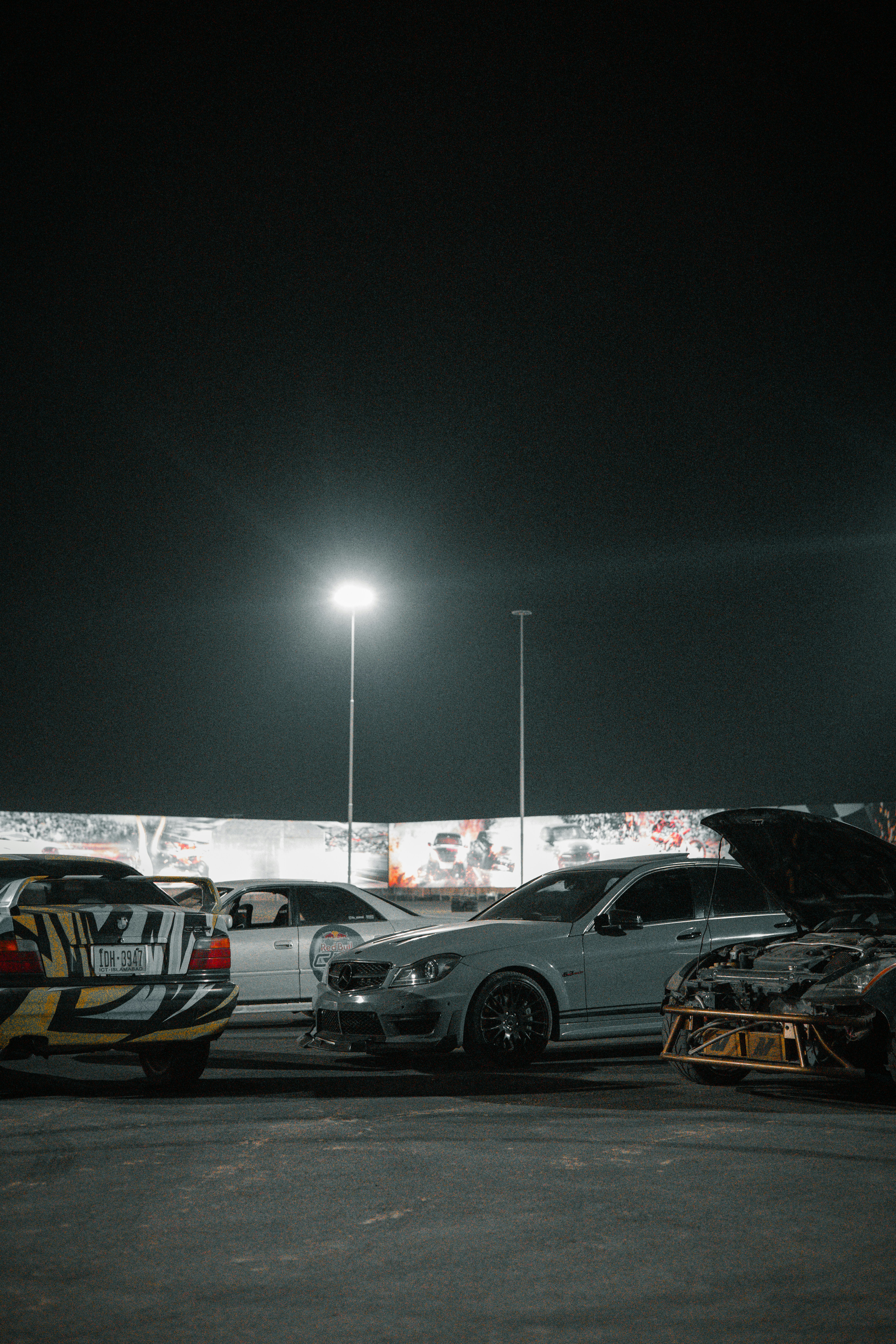 Street culture car meet with drift cars under night lights at an OFFSCRIPT subculture activation