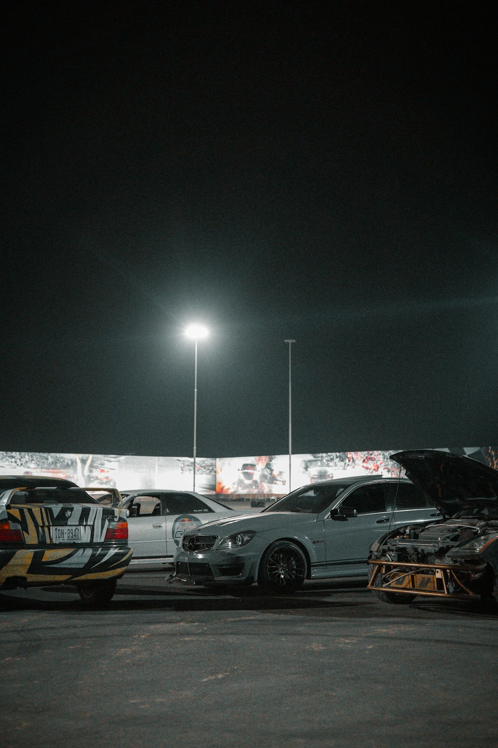 a couple of cars parked next to each other in a parking lot