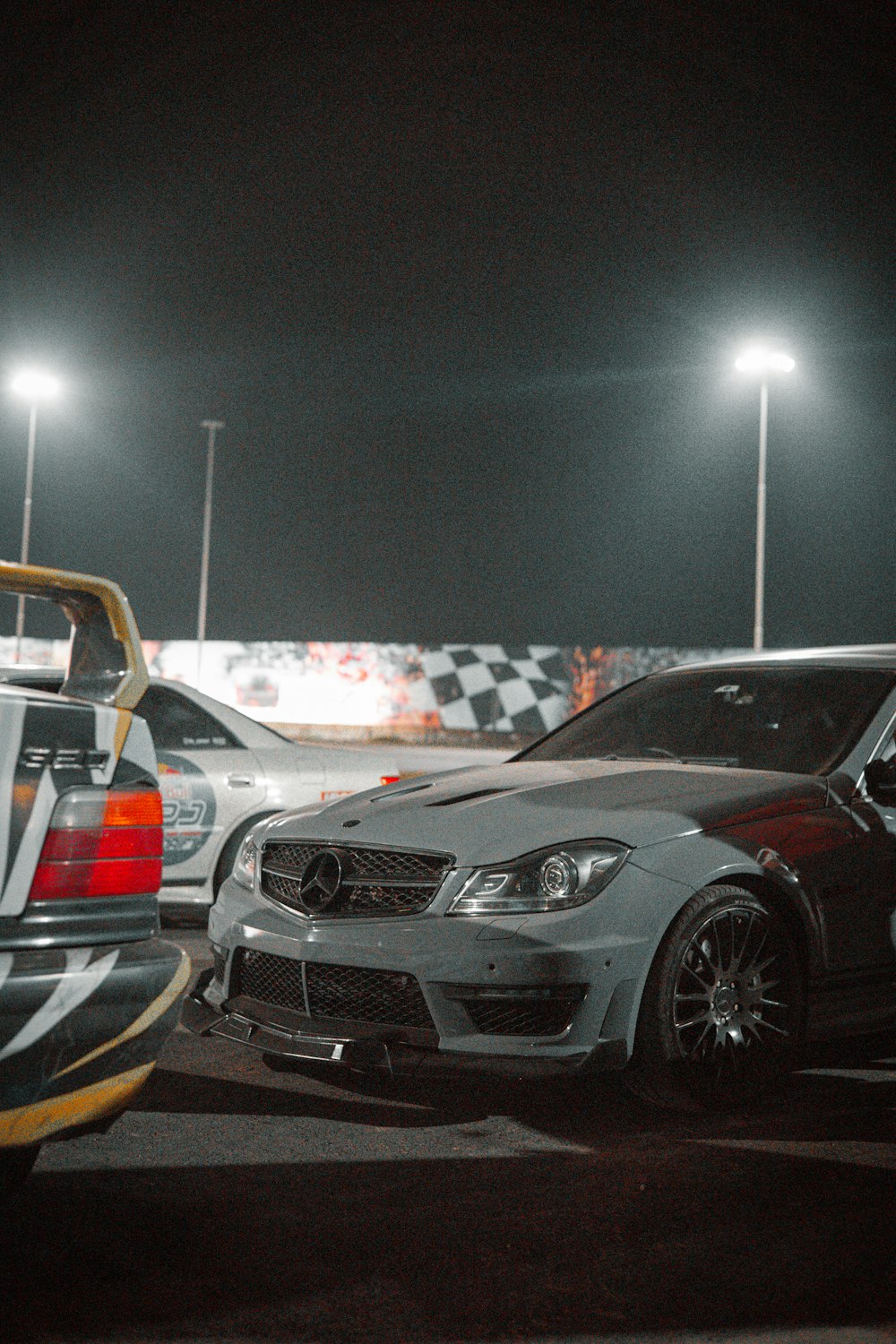 a couple of cars parked next to each other in a parking lot