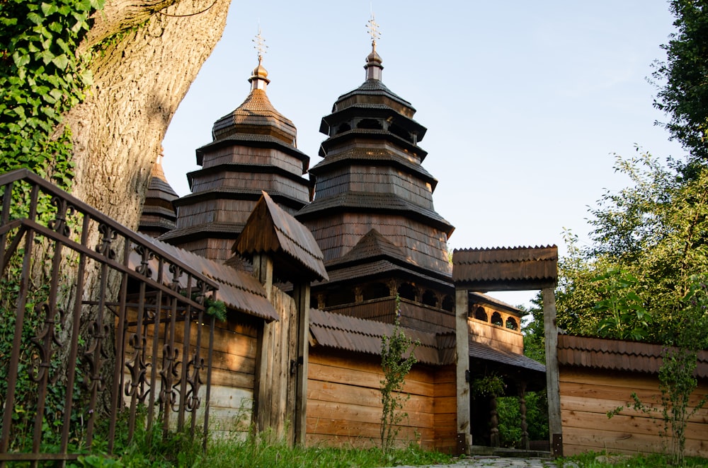 a wooden building with two towers and a gate