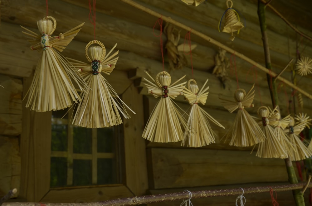 a group of angel decorations hanging from a ceiling