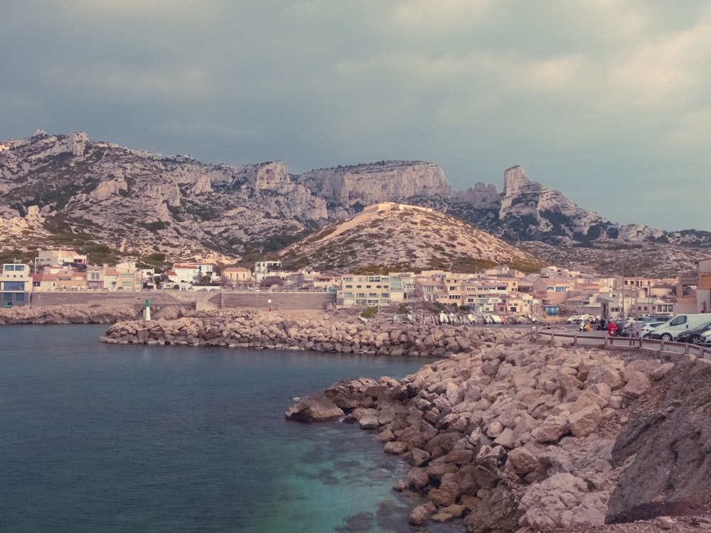 a body of water next to a rocky shore