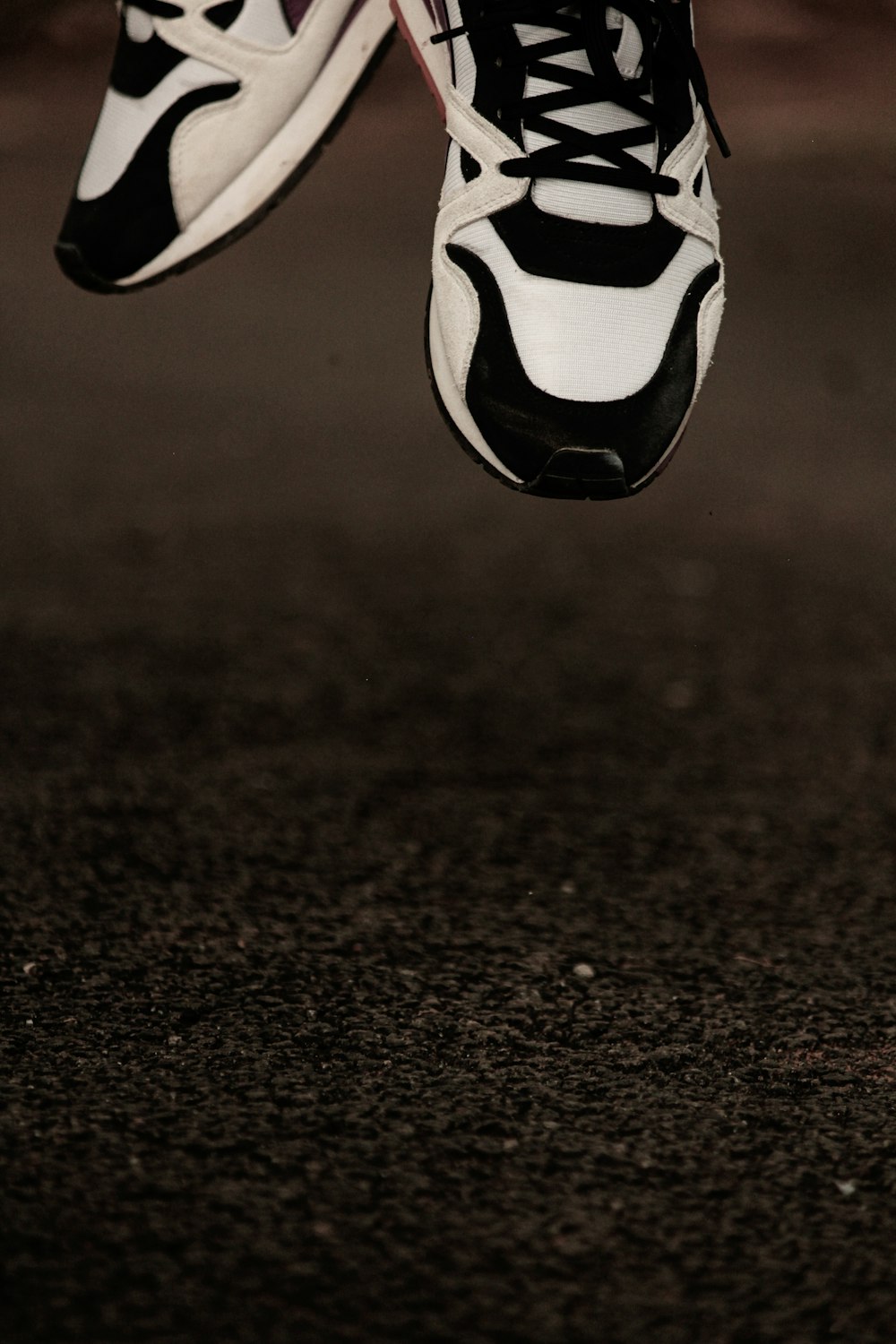 a pair of shoes hanging from the side of a building